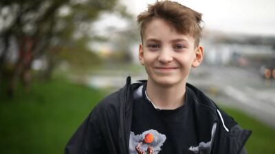 young man walking and smiling