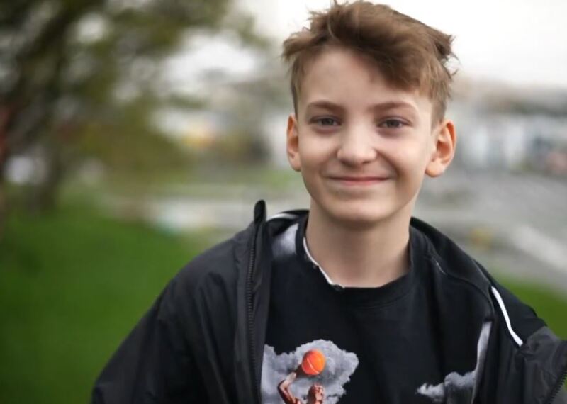 young man walking and smiling