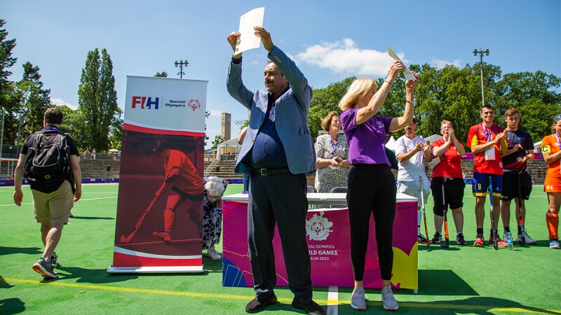 Mary Davis, CEO of Special Olympics Inc. and Tayyab Ikram, President of International Hockey Federation, holding up the signed Memorandum of Understanding. 