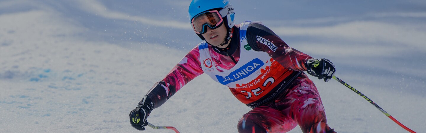 Female athlete skiing down hill. 