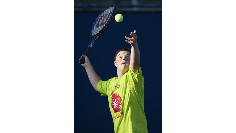 A male tennis player serving the ball at Special Olympics World Summer Games Los Angeles 2015