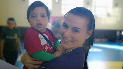 Woman holds a toddler in arms