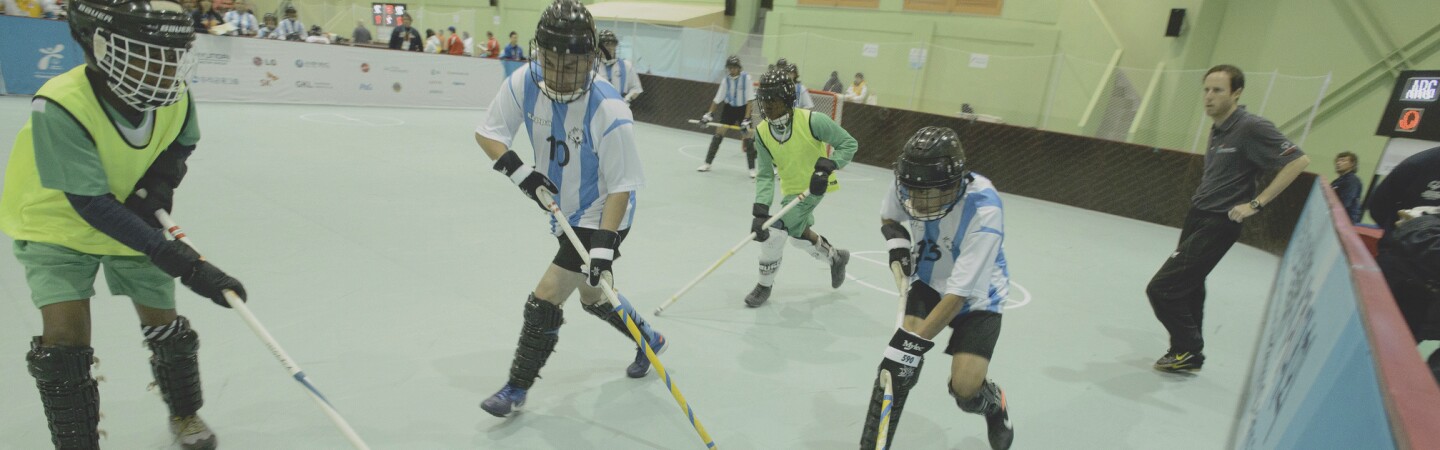 An athlete with the puck tries to make his way past a player for the opposing team. 