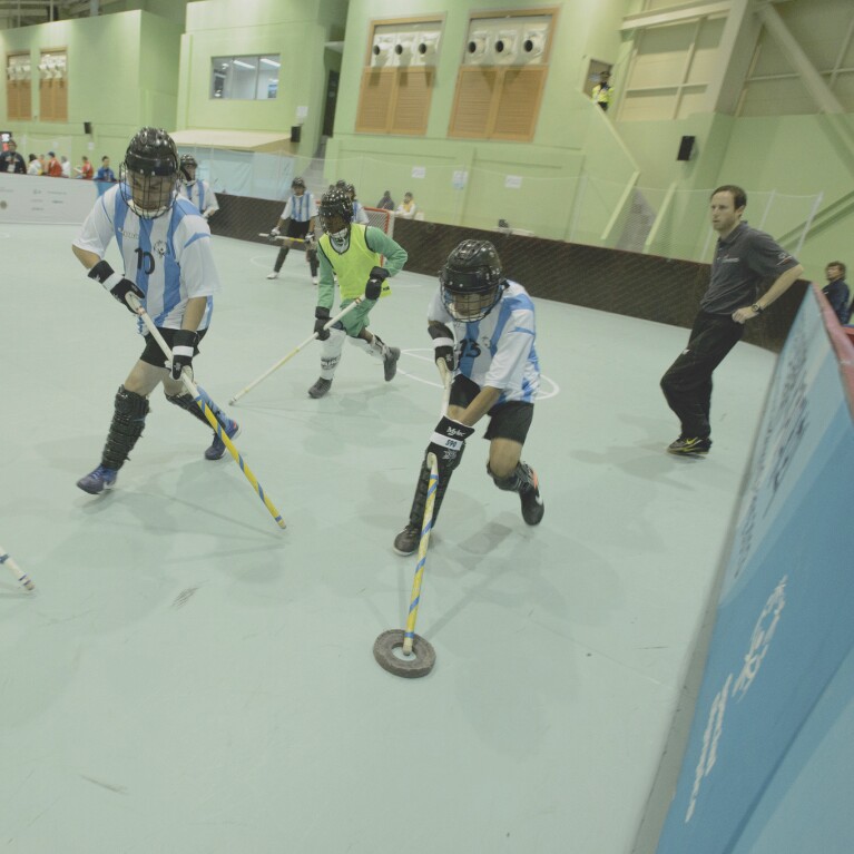 An athlete with the puck tries to make his way past a player for the opposing team. 