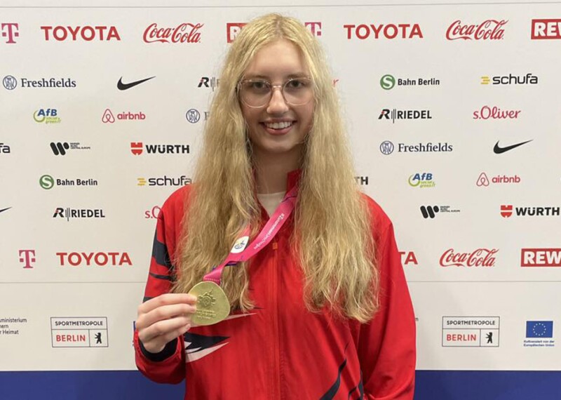 Taylor Mackenzie showing off her medal. 