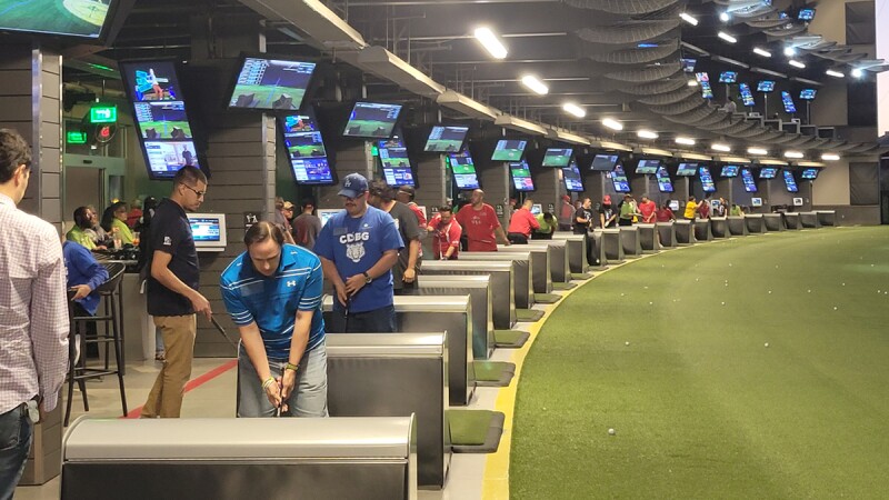 Golfers in a row swinging golf clubs