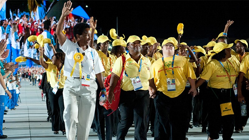 Loretta Claborne walking with a delegation of athletes. 