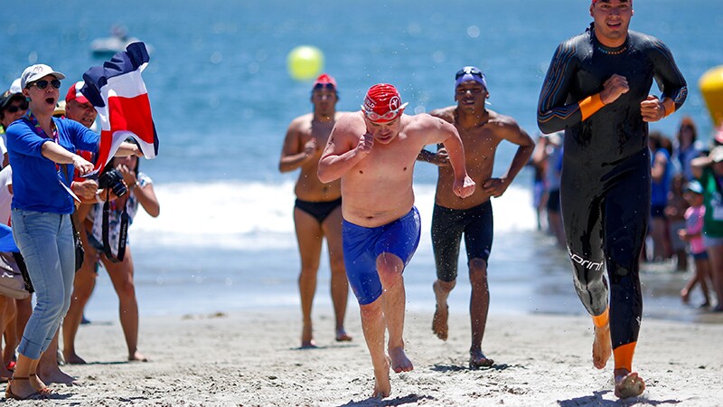 Athletes running up from the water on the beach during the triathlon at Special Olympics World Summer Games Los Angeles 2015