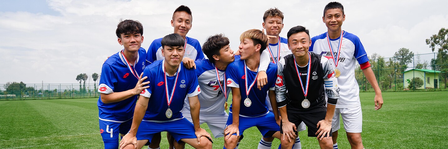 Footballer team photo on the pitch. 