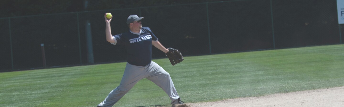 Male softball player preparing to throw the ball. 