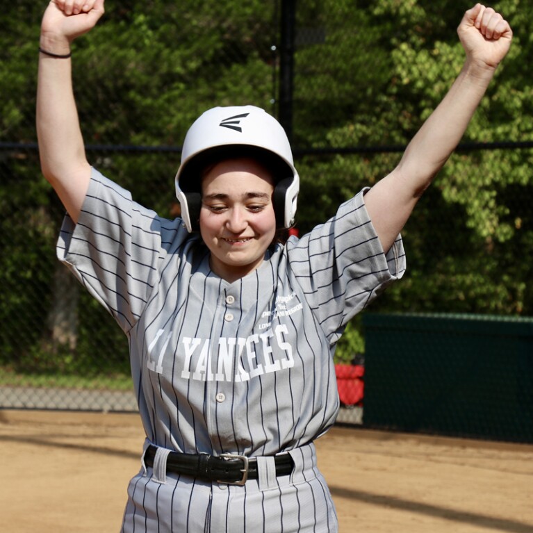 Female athletes with arms in cheering. 