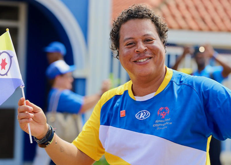 A Special Olympics athlete smiles for the camera. 